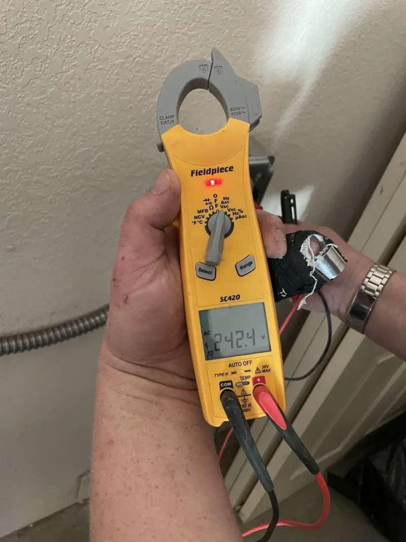 Voltage testing with clamp meter during Outlet Installation in Lantana